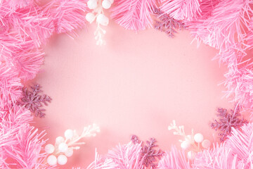 Kitschmas Christmas background with fluffy pink artificial Christmas tree brunches, pink festive...