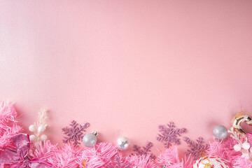 Kitschmas Christmas background with fluffy pink artificial Christmas tree brunches, pink festive...