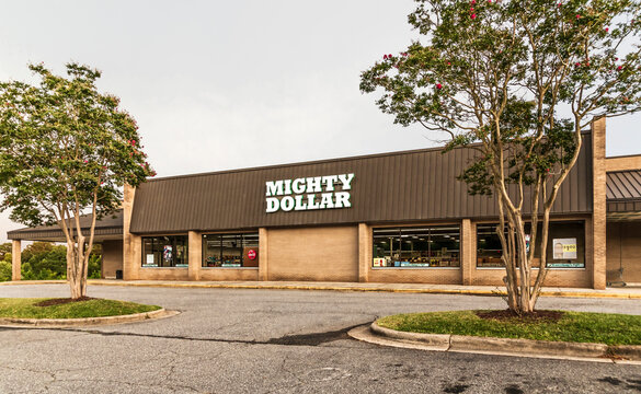 MOUNTAIN VIEW, NC, USA-21 AUGUST 2019: One of a chain of Mighty Dollar dollar stores.  Shows storefront, parking lot, and shoppers within.