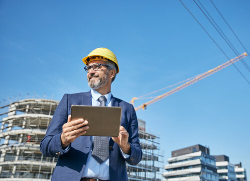 businessman construction site business architect building engineer builder tablet helmet architecture blueprint worker man contractor adult engineering industry