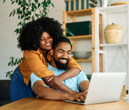 laptop man woman computer technology home couple young together happy happiness smiling togetherness male internet online wife love