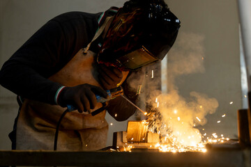professional welder Worker using tig welding method on a piece of steel