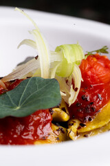 Italian pasta, ravioli, with tomato and vegetables.