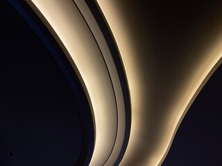 Modern office lighting. Thin lamps in office dark ceiling. LED white cold light over workplaces. Neon light arrow direction in perspective