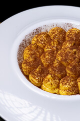Classic italian dessert, tiramisù. An cheescake with cocoa, eggs, coffee and italian biscuits, savoiardo.