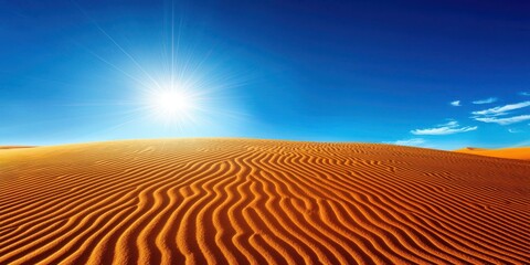 Naklejka premium A vast desert landscape featuring golden sand dunes under a bright blue sky, with the sun shining brightly overhead.