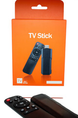 Remote control and TV stick next to product box without logo without brand ready to use in marketing selective focus, copy space
