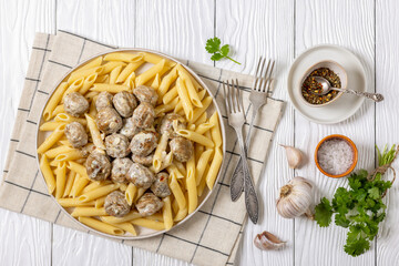 Ground chicken meatballs with penne pasta on plate