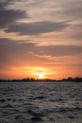 Sunset at Langweerder Wielen (Frisian: Langwarder Wielen), Frisian Lake in the Netherlands. View of the church tower of Langweer. 