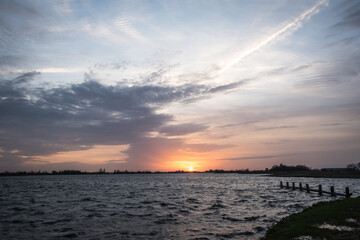 Sunset at Langweerder Wielen (Frisian: Langwarder Wielen), Frisian Lake in the Netherlands. View of the church tower of Langweer. 