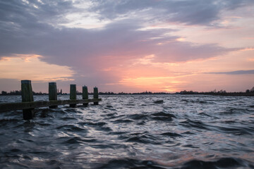 Sunset at Langweerder Wielen (Frisian: Langwarder Wielen), Frisian Lake in the Netherlands. View of the church tower of Langweer. 