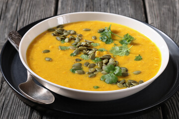 Pumpkin Red Lentil Soup in white bowl, top view