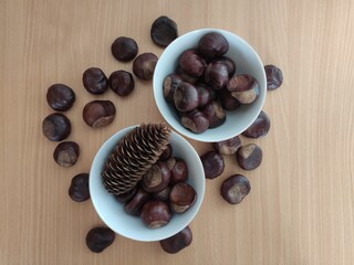 Yellow lemons and shiny brown chestnuts on the table