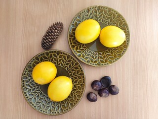 Yellow lemons and shiny brown chestnuts on the table