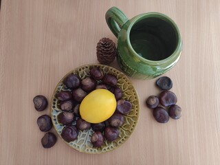 Yellow lemons and shiny brown chestnuts on the table