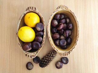 Yellow lemons and shiny brown chestnuts on the table