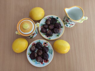 Yellow lemons and shiny brown chestnuts on the table