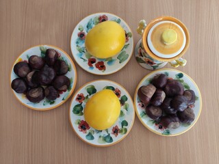 Yellow lemons and shiny brown chestnuts on the table