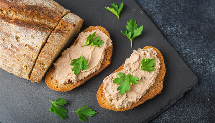 Crusty bread with smooth liver pate and fresh herbs. Tasty snack for lunch. Cooking and culinary
