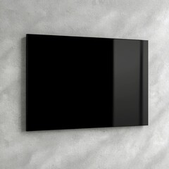 A sleek, modern black panel mounted on a textured gray wall, suggesting minimalistic design and contemporary aesthetics.
