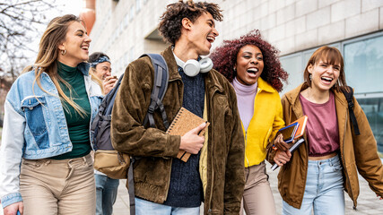 Happy university students walking in college campus - Group of smiling young people hanging...