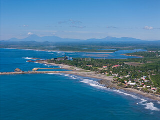 Coastal landscape featuring clear blue waters and serene shoreline during daytime