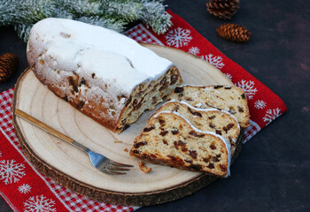 Traditioneller deutscher Weihnachtskuchen: Christstollen auf einem Holzbrett .