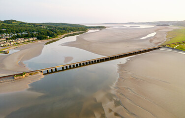 Arnside rail railway viaduct across the River Kent Estuary at village of Arnside. Cumbria, England....