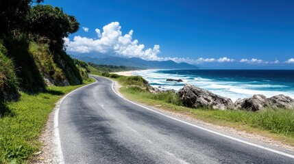 A tropical coastal drive lined with lush greenery, vibrant blue sea, and wispy clouds paints a picturesque scene, inviting one to embrace nature&rsquo;s pristine relaxation.