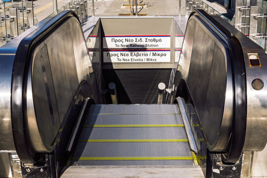 Thessaloniki, Greece new metro line 25 Martiou station escalators entrance featuring a sign in both Greek and English leading to Railway Station, Nea Elvetia and Mikra.