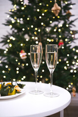 An Elegant Holiday Toast with Sparkling Champagne Enjoyed Near a Beautiful Christmas Tree