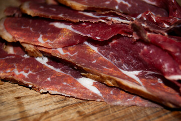 A detailed shot of dried beef on a cutting board, highlighting its rich texture and color.