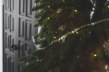 Christmas tree with glass toys and festive lights. Background for Christmas and New Year's Eve.