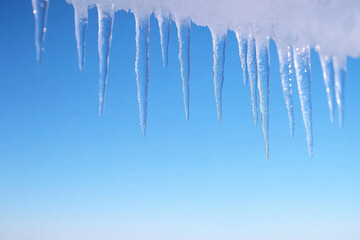 The sky is blue and clear with a few icicles hanging from it