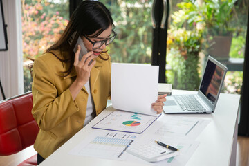 Businesswoman holding a phone talking about a housing development project