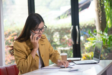 Businesswoman holding a phone talking about a housing development project