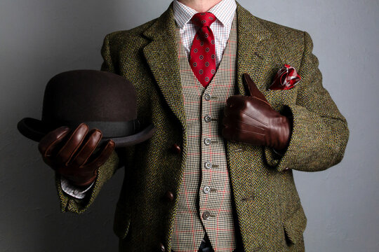Gentleman in Tweed Suit and Leather Gloves Holding Bowler Hat. Vintage Style of Classic English Country Gentleman.