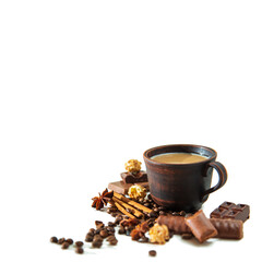 Cup of cappuccino, coffee beans, pieces of chocolate, cinnamon and star anise.