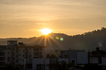 Beautiful sunrise with rays in orange color with buildings in the foreground 3