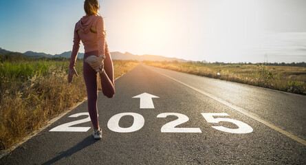 New year 2025 or start straight concept.word 2025 written on the asphalt road and athlete woman...
