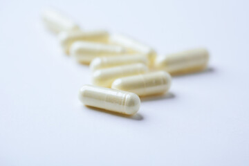 Alpha-lipoic acid capsules. Paper background. Soft focus. Close up. Copy space.