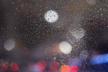 Blurred background with raindrops and lights.
