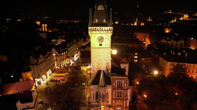 Aerial night footage of the old city center of Prague, Czech Republic. Bohemia capital Praha seen from above. Old town square, the Prague Astronomical Clock and Tyn Church seen in the evening light.
