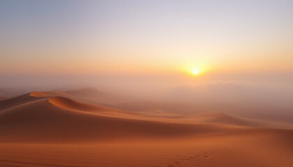 Obraz premium Desert sunrise with fog, sand dunes, and soft light.