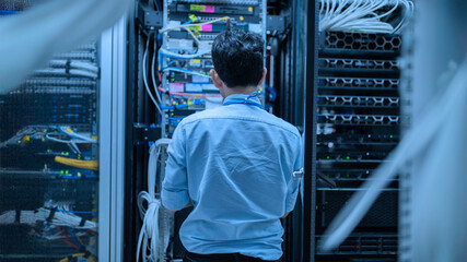Computer engineer is setting up network in server room,Systems Maintenance Technician,Male engineer...