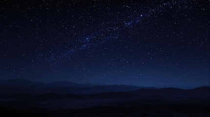 A panoramic view of a star-filled night sky with the outline of mountains or hills in the foreground, landscape, space