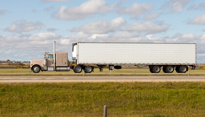 Heavy Cargo on the Road. A truck hauling freight along a highway. Taken in Alberta, Canada