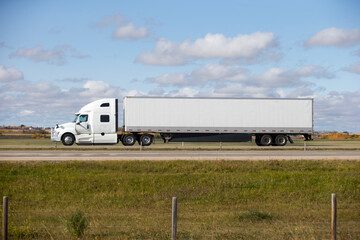 Heavy Cargo on the Road. A truck hauling freight along a highway. Taken in Alberta, Canada
