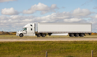 Heavy Cargo on the Road. A truck hauling freight along a highway. Taken in Alberta, Canada