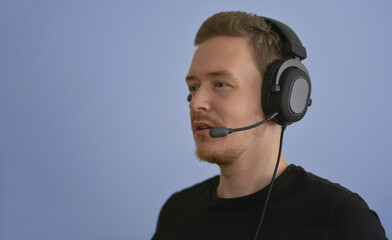 Man working with headphones and microphone. Support service operator talking with a client. Call...